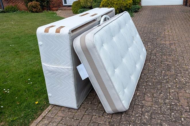 old mattress being taken away for disposal